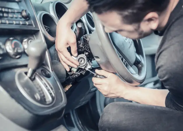 Technician working on a steering-column ignition